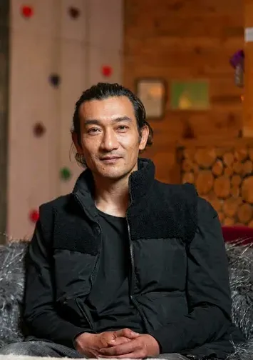 Samraj Gurung, Managing Partner and Farmhouse Director, seated in the farmhouse lounge